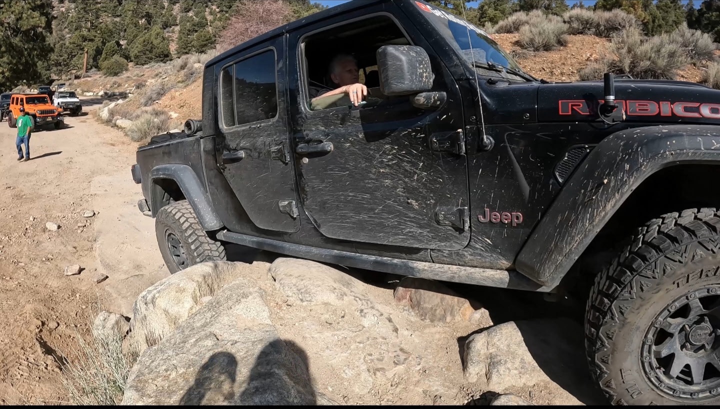 Side view of the Get Rolling Jeep articulating over trail boulders